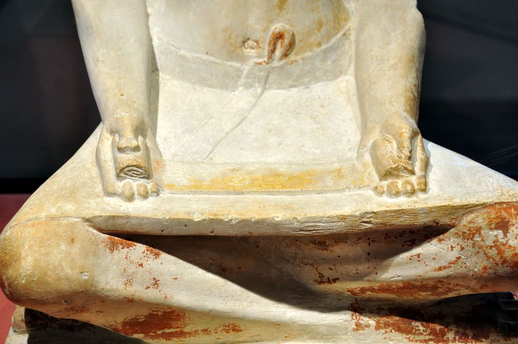 Ancient Egyptian limestone sculpture of a seated scribe at work from the Fifth Dynasty, 2494 to 2345 BC