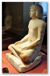 Ancient Egyptian limestone sculpture of a seated scribe at work from the Fifth Dynasty, 2494 to 2345 BC