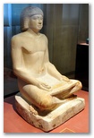Ancient Egyptian limestone sculpture of a seated scribe at work from the Fifth Dynasty, 2494 to 2345 BC