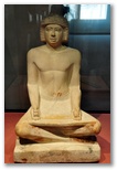 Ancient Egyptian limestone sculpture of a seated scribe at work from the Fifth Dynasty, 2494 to 2345 BC