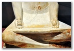 Ancient Egyptian limestone sculpture of a seated scribe at work from the Fifth Dynasty, 2494 to 2345 BC